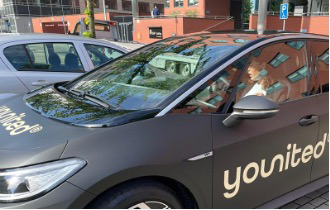 An RGF Staffing employee driving an electric car to see clients.